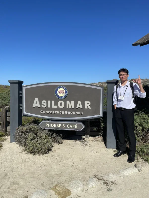 Van Tien Nguyen beside the Asilomar Conference Grounds sign.